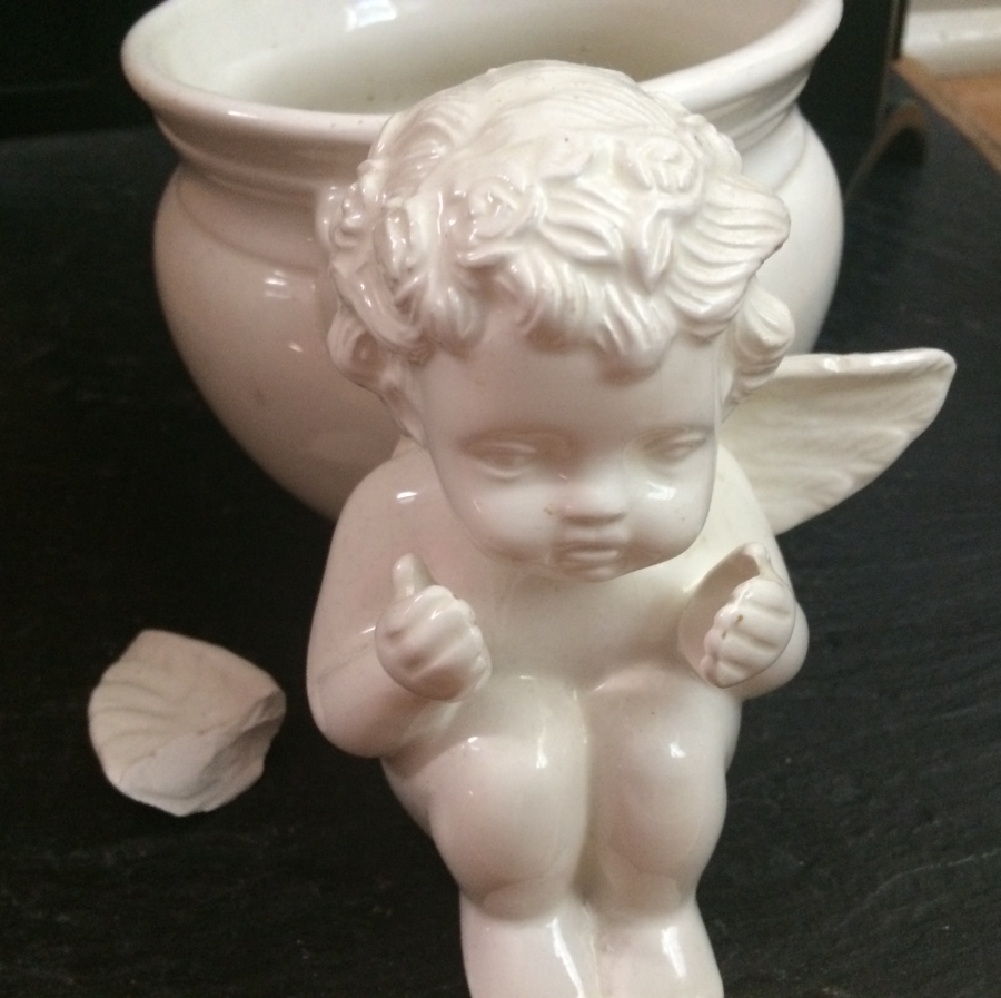 cherub pot with one wing broken off